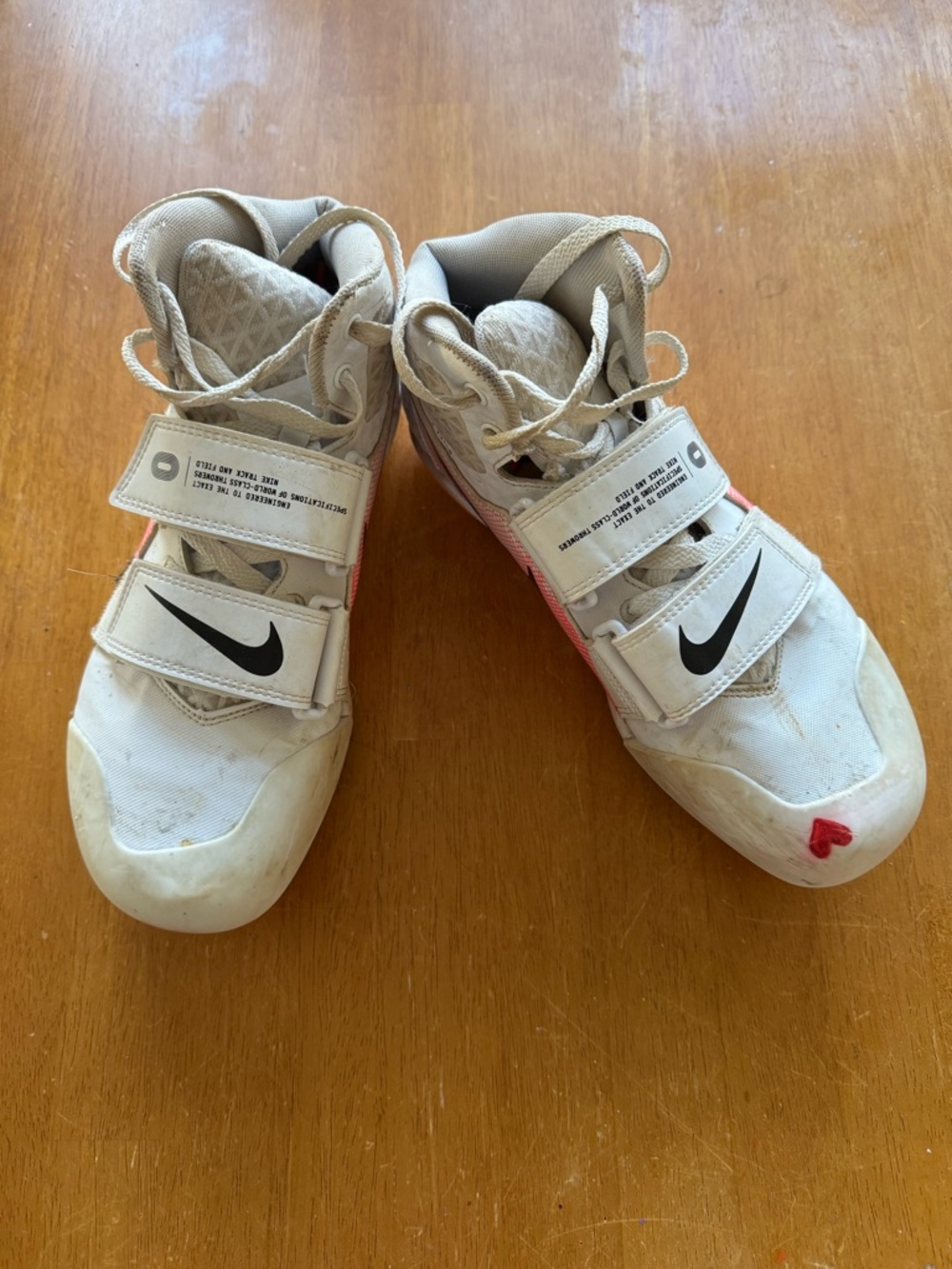 Nike White High-Top Javelin Throwing Shoes with Black Swoosh and Pink Accent